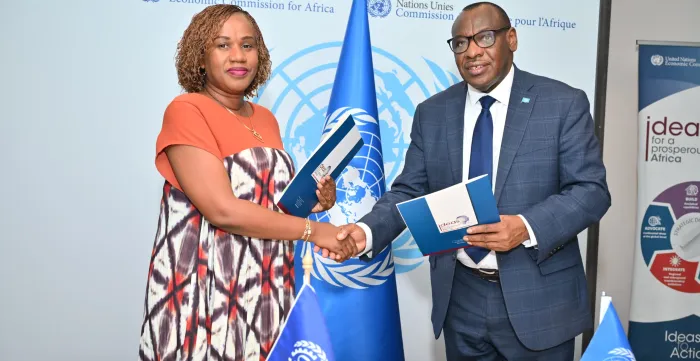 ILO and ECA officials shaking hands and exchanging documents