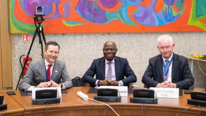 ILO programme on living wages with IOE, ILO DG and ITUC sitting at a wood table smiling into the camera