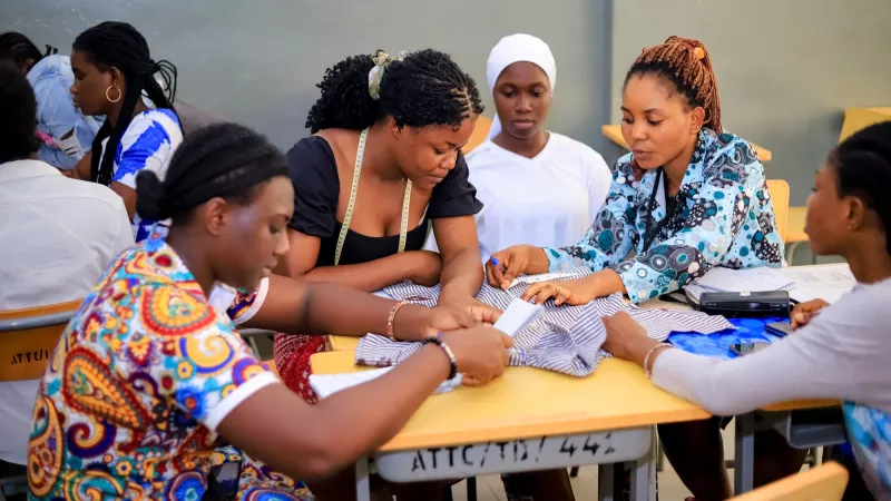 Five women working on a group assignment