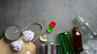 Photo of bottles, tin cans, paper to be recycled