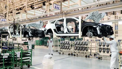 Workers in Thailand at an auto parts manufacturing plant